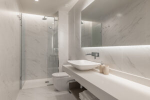 An elegant accessible walk-in shower with a curbless entry and bench.