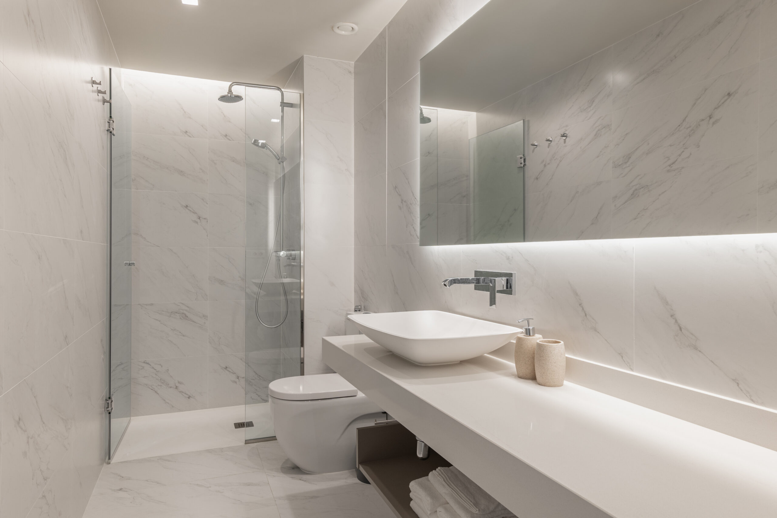 An elegant accessible walk-in shower with a curbless entry and bench.